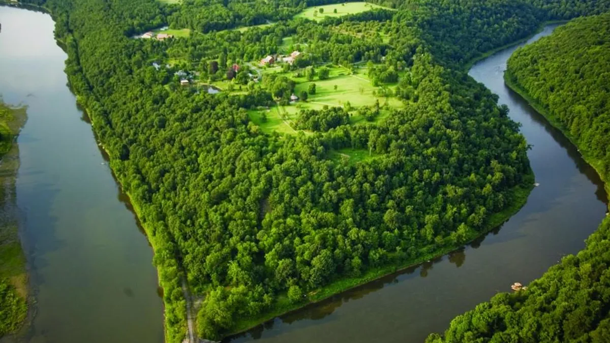 An aerial shot of the confluence of two rivers.