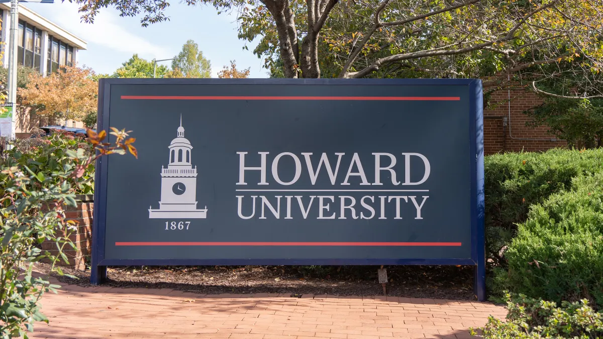 A sign that says Howard University at the entrance to a campus.