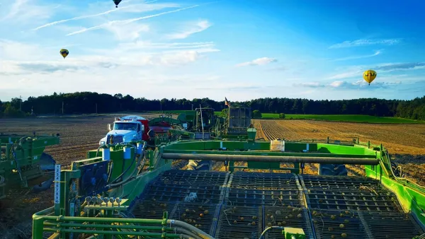 A close up of a potato harvester is seen