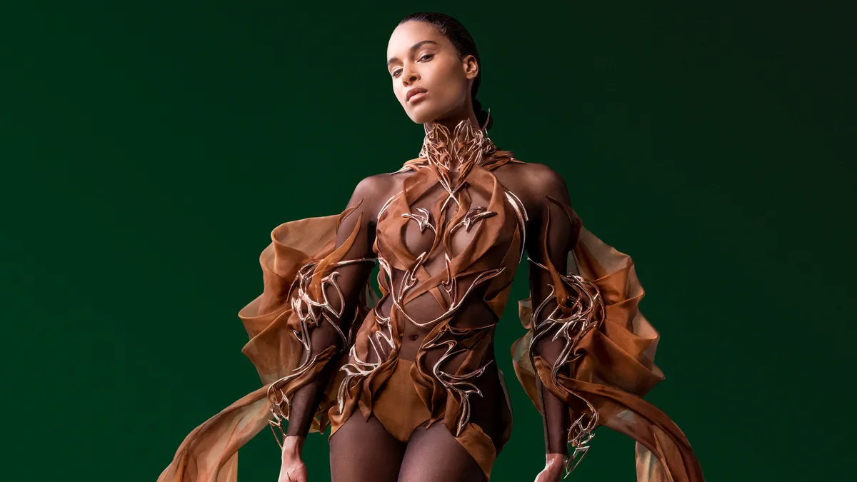 A model wears a dress made out of cocoa beans