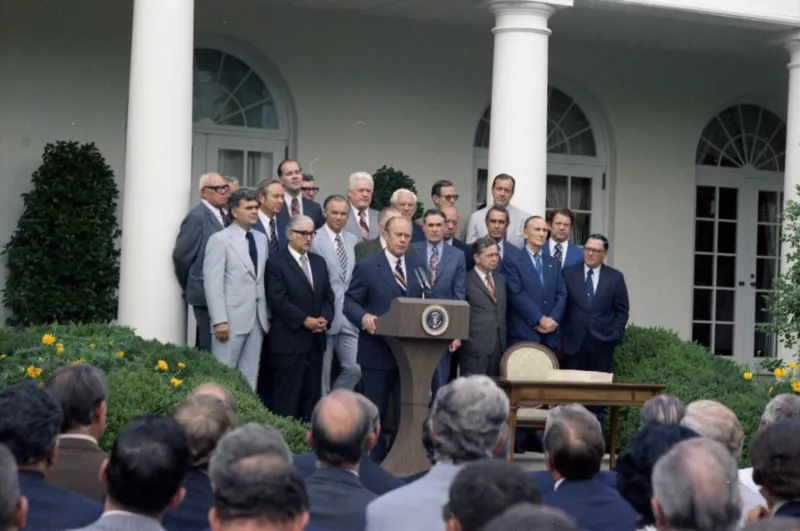 President Gerald Ford holds White House press conference announcing passage of ERISA.