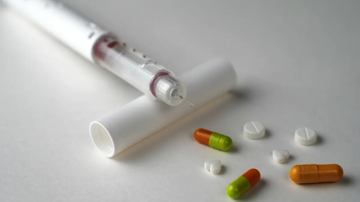 A picture of tablets and injectable medicines for obesity.