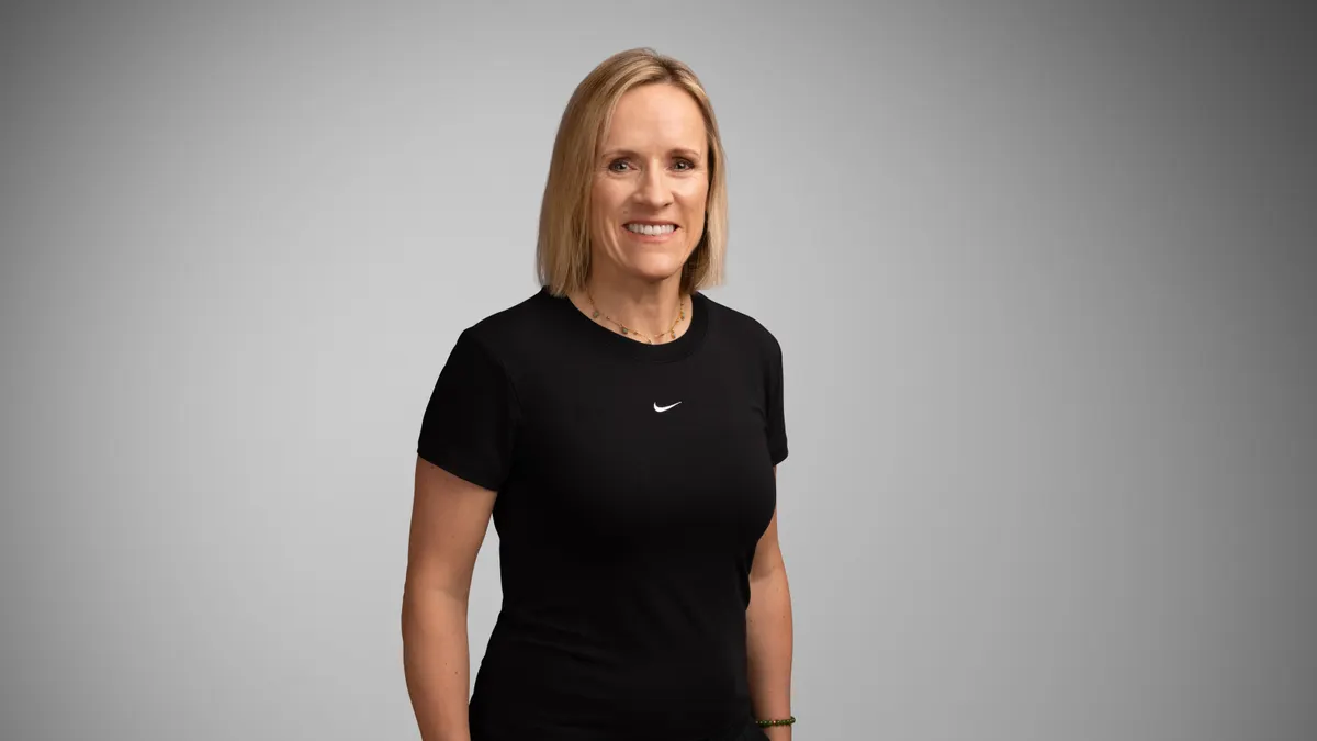 A headshot of Nike executive Jane Ewing in a black T-shirt with the Nike swoosh.