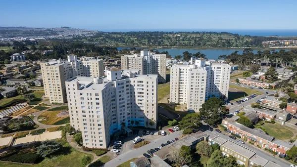 Aerial picture of four-building high-rise apartment complex.