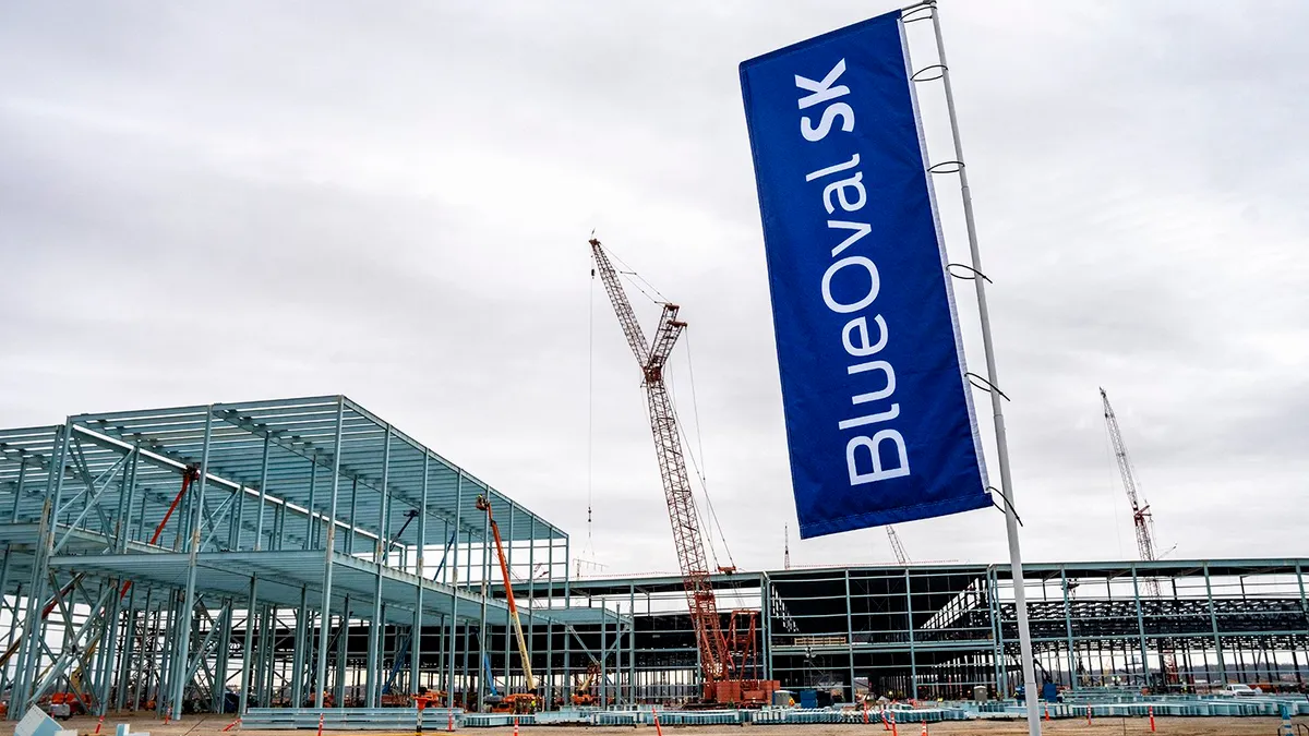 An exterior view of the BlueOval SK battery plant under construction in Tennessee showing the building's steel framing.