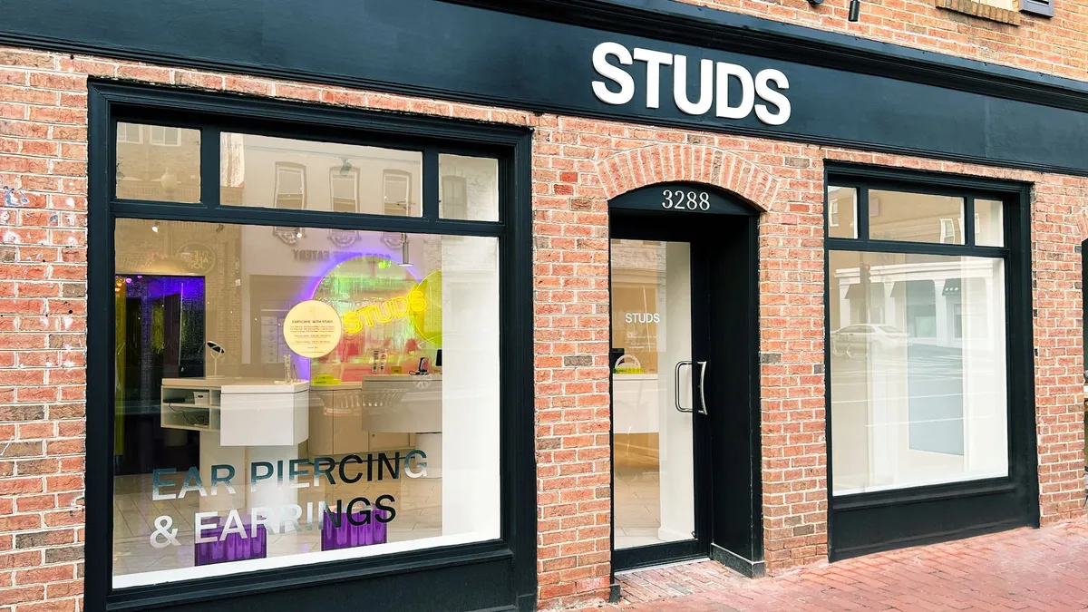 A black and red brick storefront by Studs