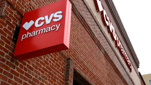 A brick wall with a red CVS Pharmacy sign.