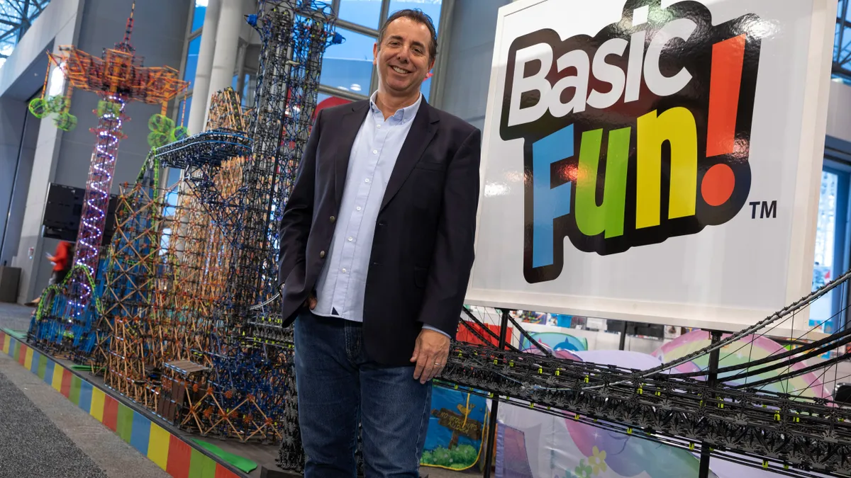 Jay Foreman stands near a toy display with the Basic Fun company logo in the background.