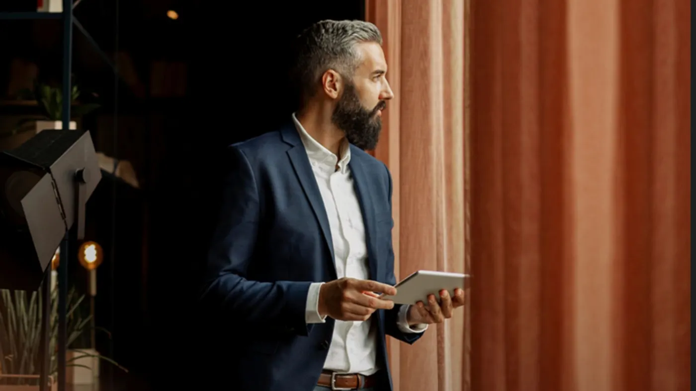 Person standing with a tablet