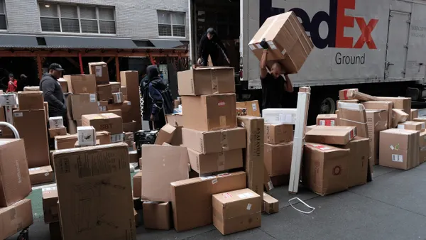 Dozens of packages are lined up along a Manhattan street as a FedEx truck makes deliveries on December 6, 2021 in New York City.