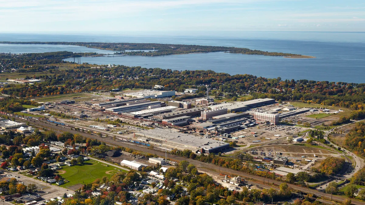 Wabtec's manufacturing plant in Erie, Pennsylvania with green landscape and a body of water behind it.