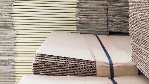 A close-up view of corrugated boxes that are banded together and stacked.