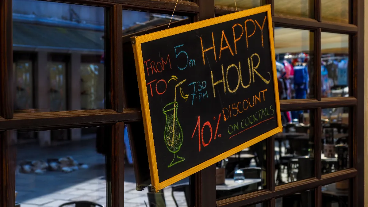 An image of a happy hour sign at a restaurant.