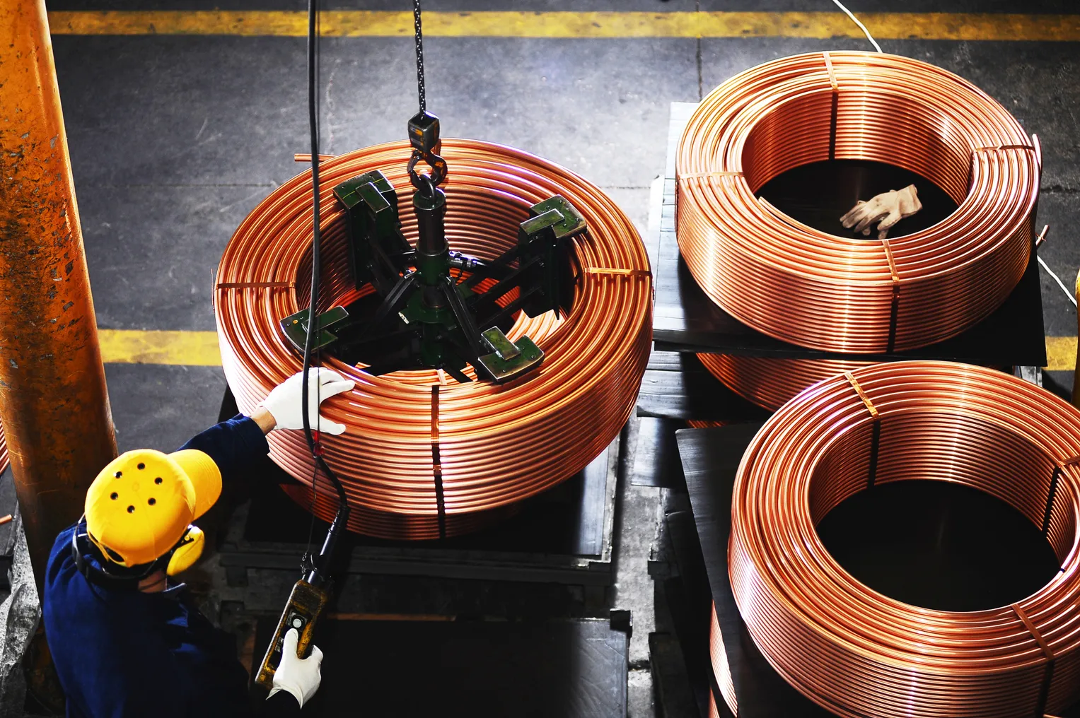 An overview of a worker testing copper coils.