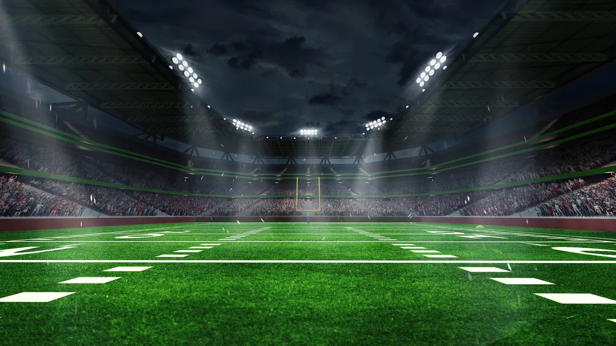 3d render of an American football arena with yellow goal post, grass field and blurred fans at playground view