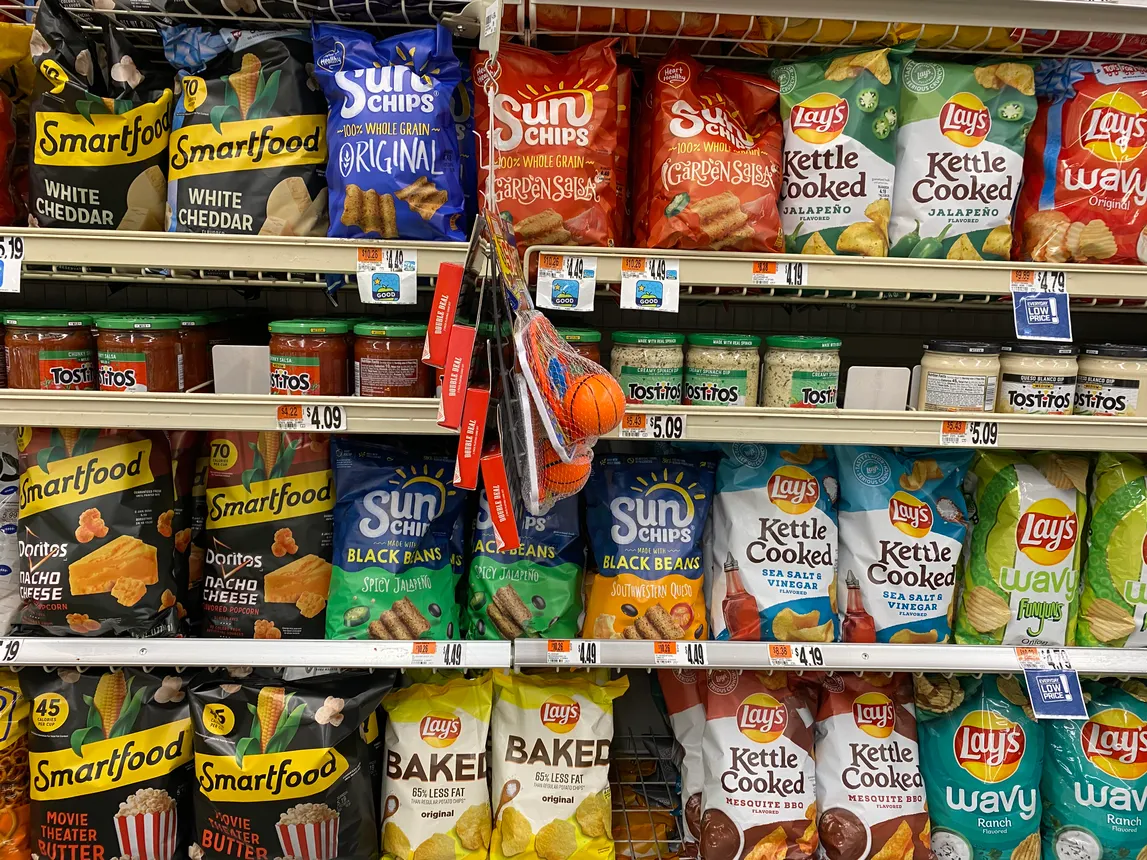 Snacking brands made by PepsiCo's Frito-Lay division on a grocery store shelf in Washington, D.C.