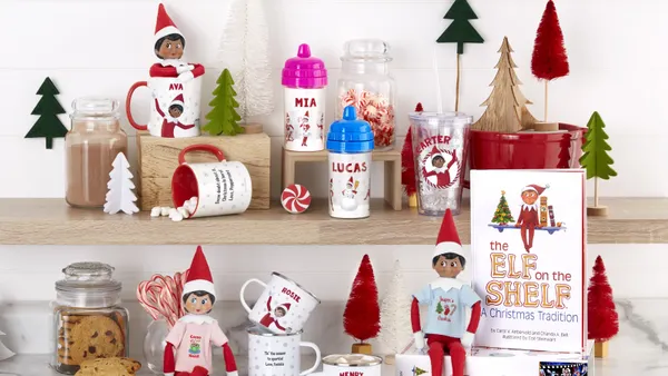 Displayed assortment of Elfs on shelves with customized mugs and books.