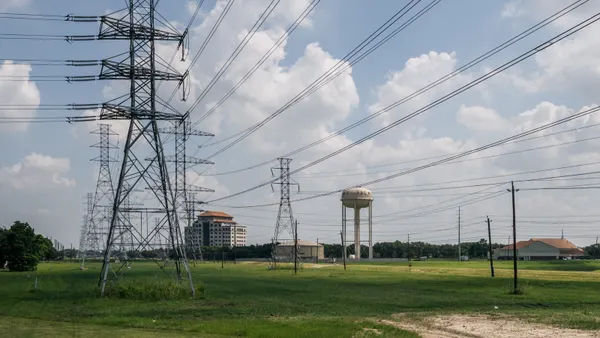 Electric power lines cross a field.