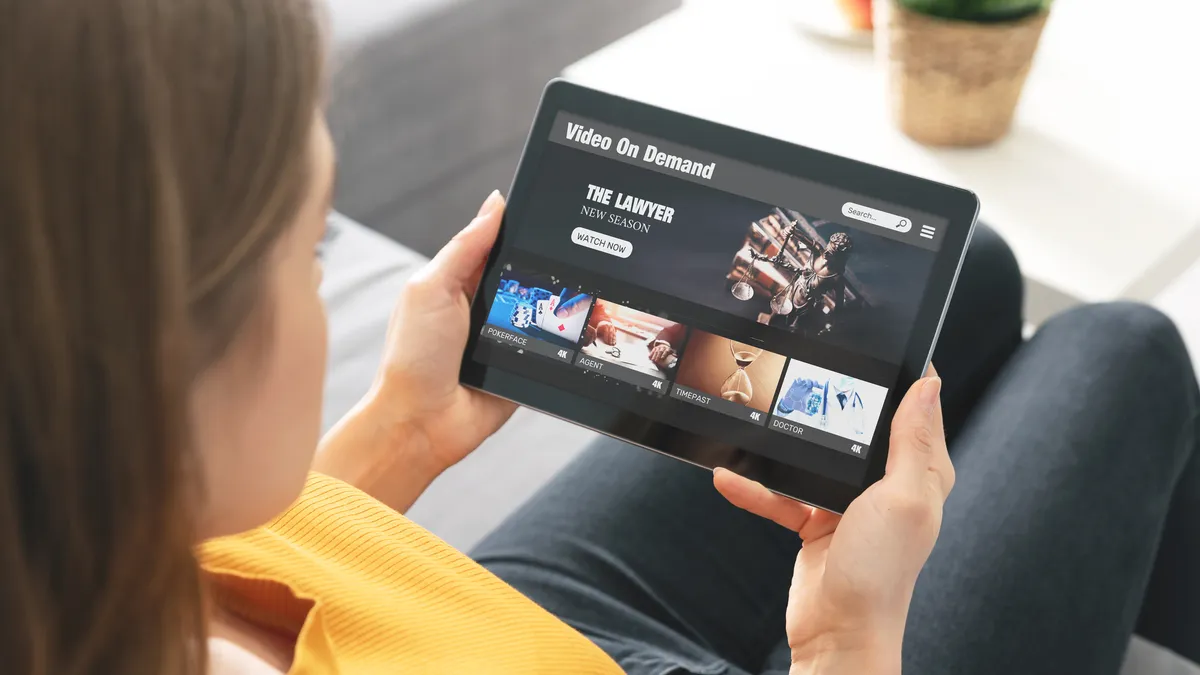 A woman watches a legal program on her tablet