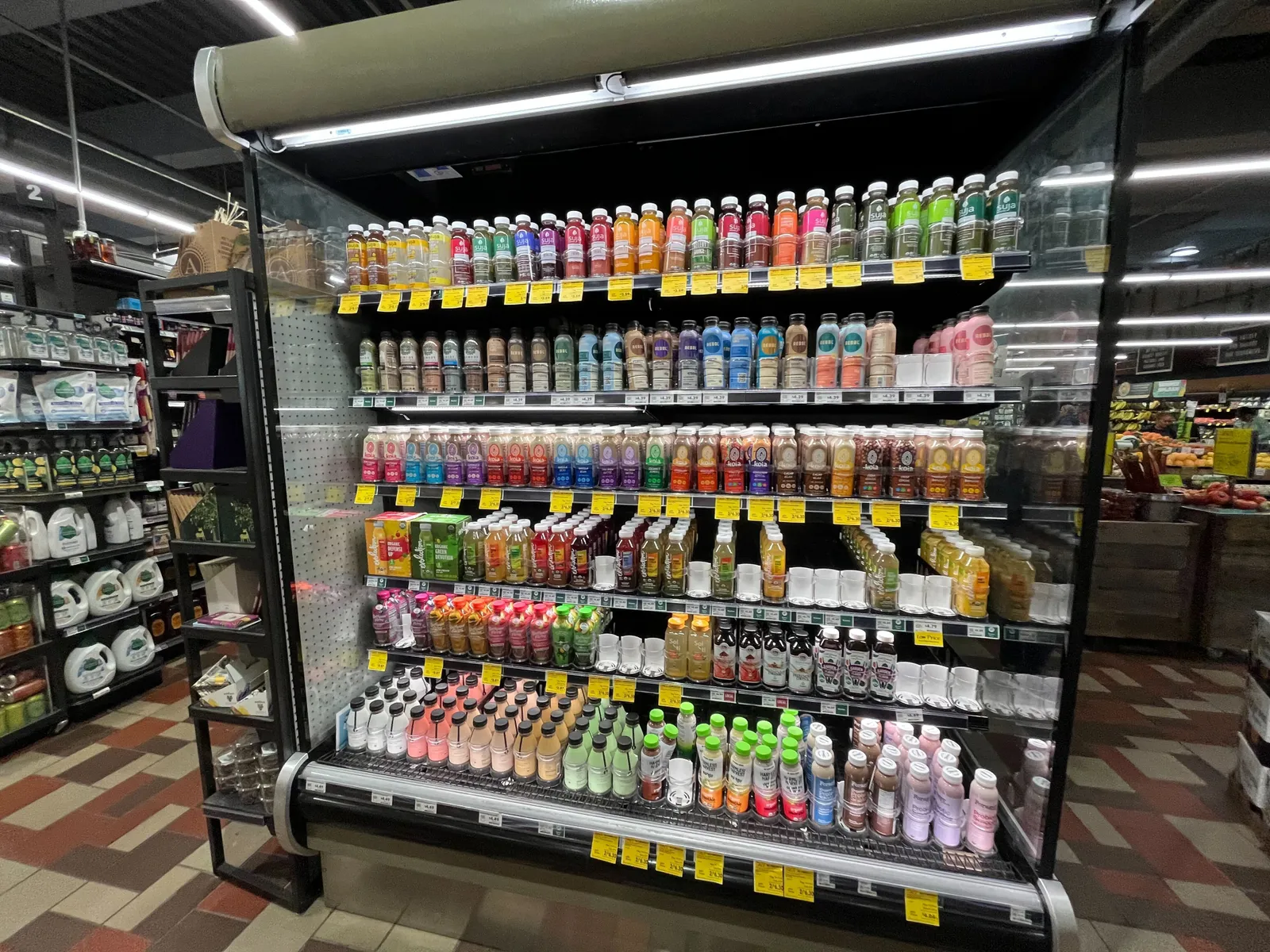 Whole Foods in-store drink refrigeration display with a lot of yellow tags