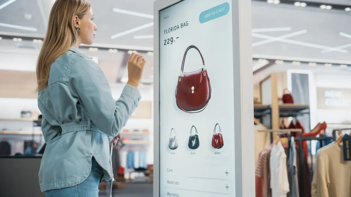 Woman shopping infront of shopping screen in store