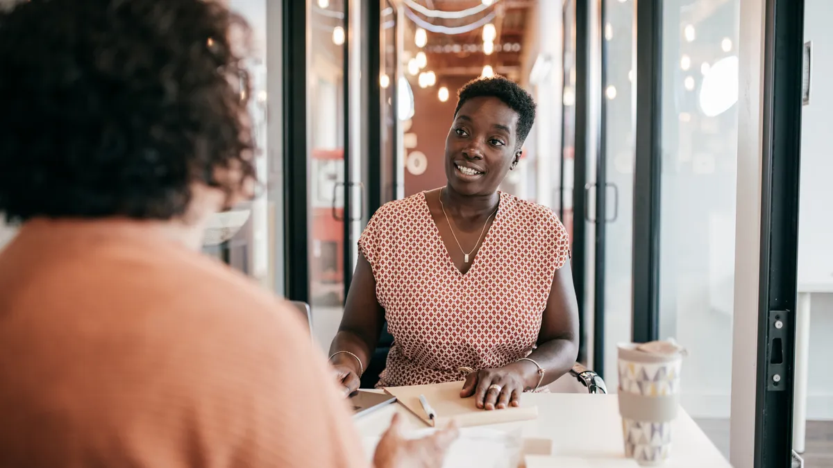 Woman speaking to job candidate