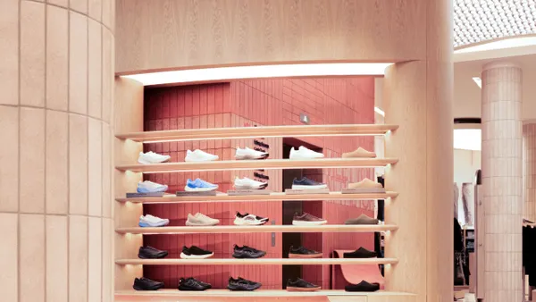 A rack of shoes in a brightly lit store.