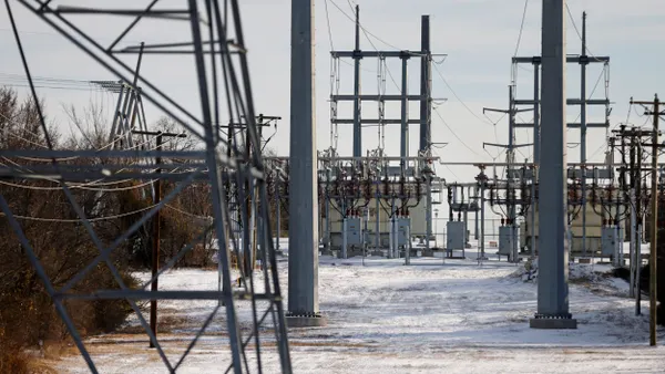 Transmission towers and power lines lead to a substation.