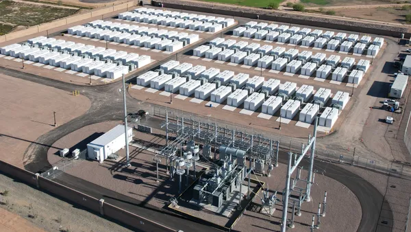 An aerial view of an industrial facility on the edge of a town.