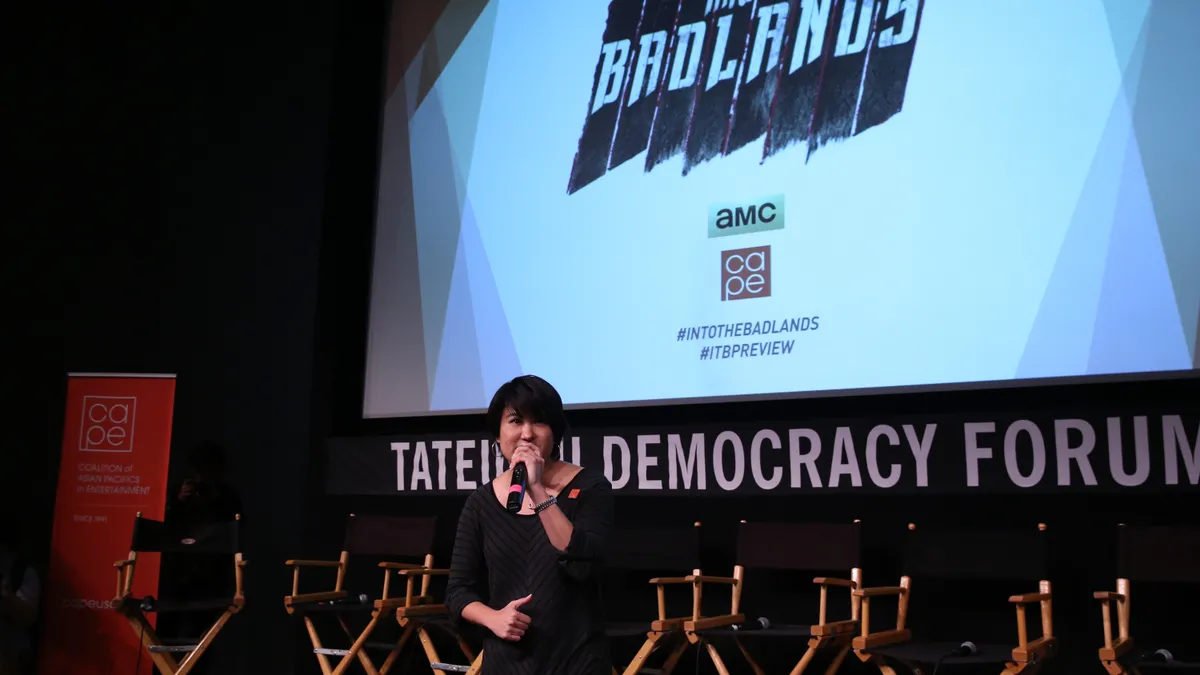 Michelle Sugihara, Executive Director, Coalition of Asian Pacifics in Entertainment, speaks onstage at an AMC and CAPE event.