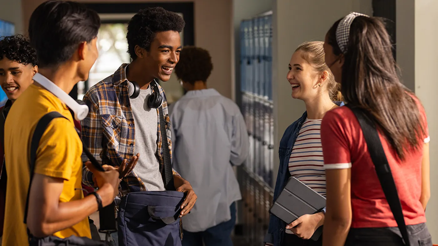 Students talking to one another in a school hallway