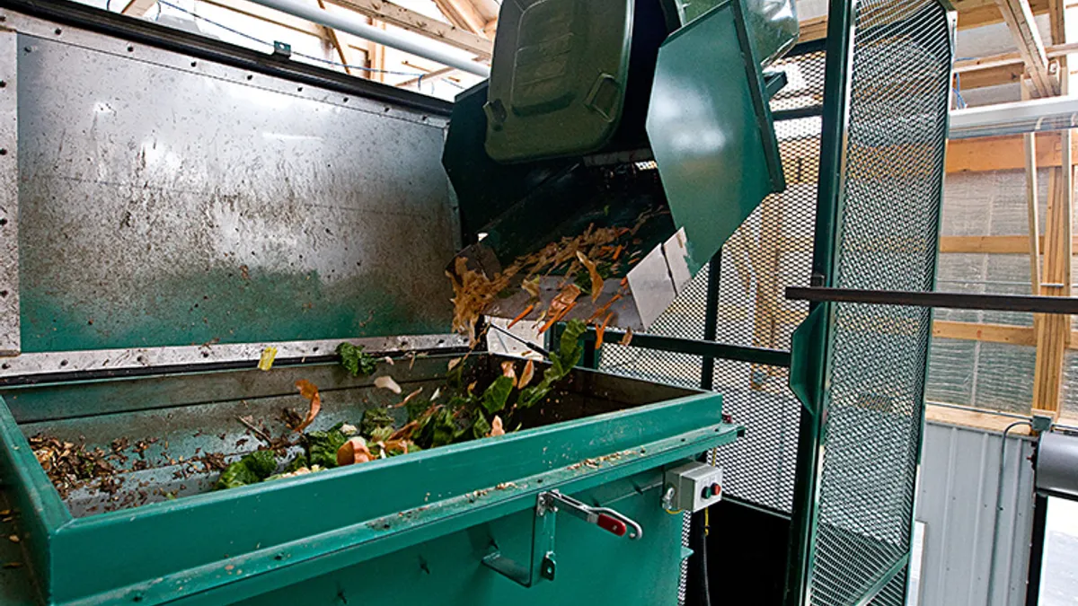 A food waste bin is poured into Ohio University's in-vessel composting vessel.