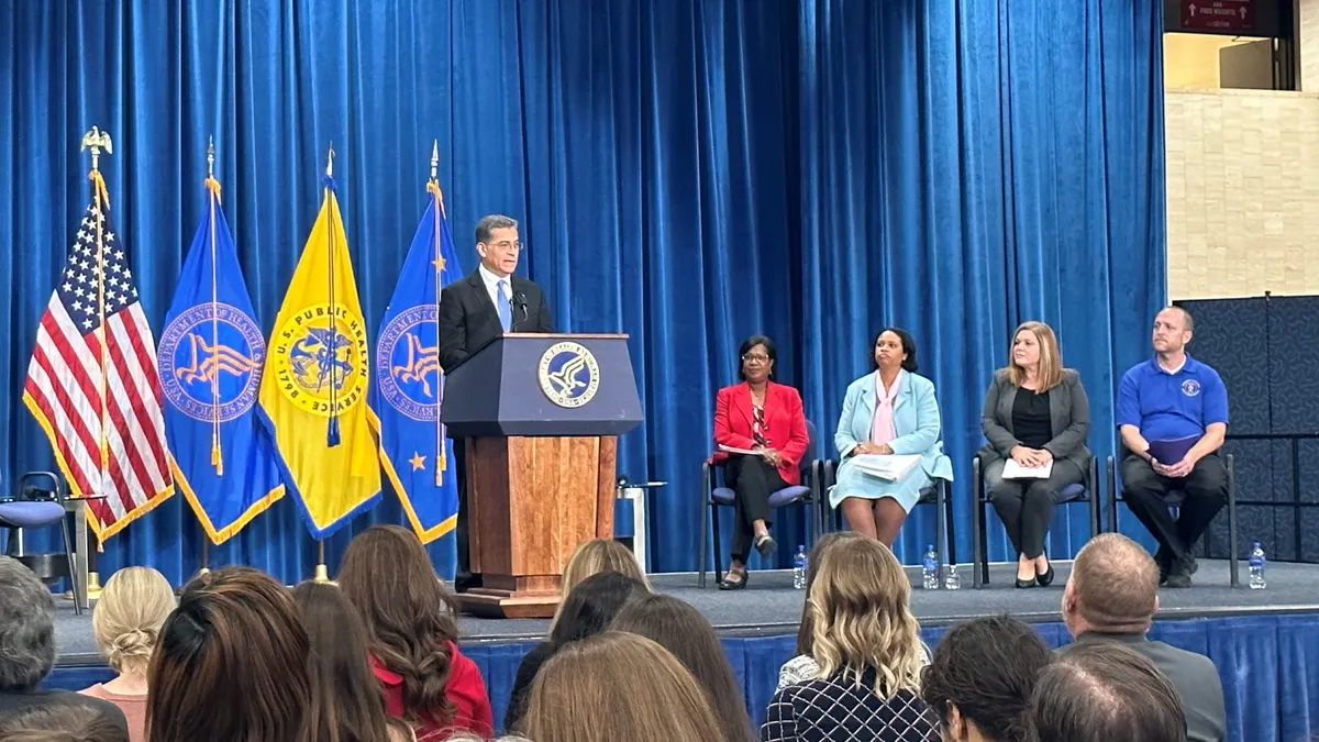 HHS Secretary Xavier Becerra speaks at a press conference