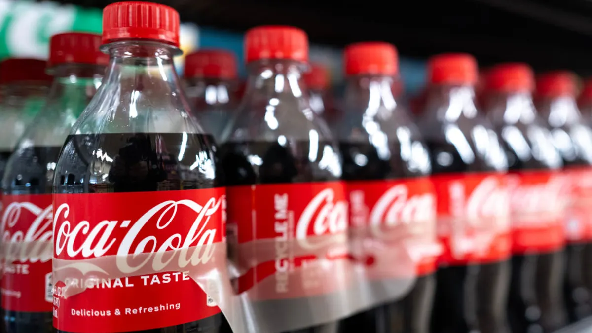 A row of Coca-Coca soda bottles