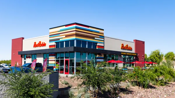 A photogrpah of a multi-colored building with a sign in red that says "Red Robin."