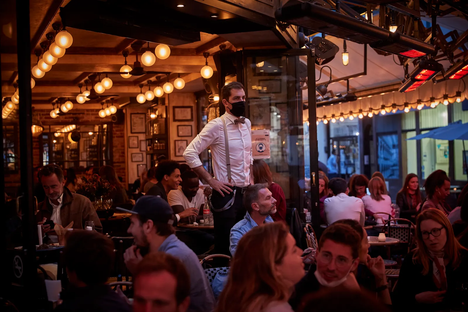 PARIS, FRANCE - SEPTEMBER 24: A waiter looks out on the terrace of a Paris bar the day after the French Government announced that from Monday all Bars and cafes in Paris will be made to shut at 10pm a