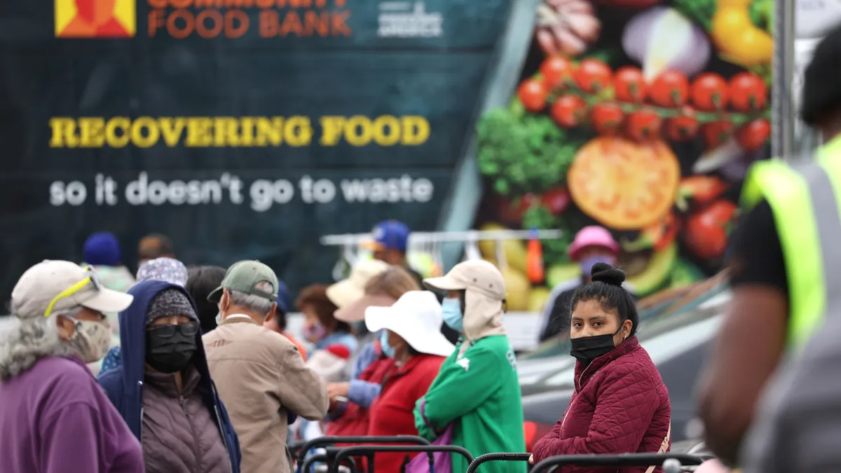 People wait in line for food donations in Oakland, California.