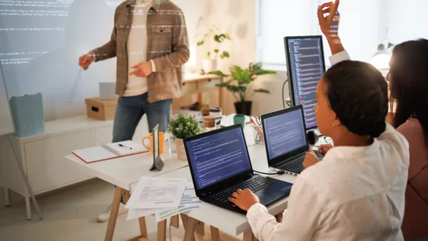 two workers in a technology education classroom