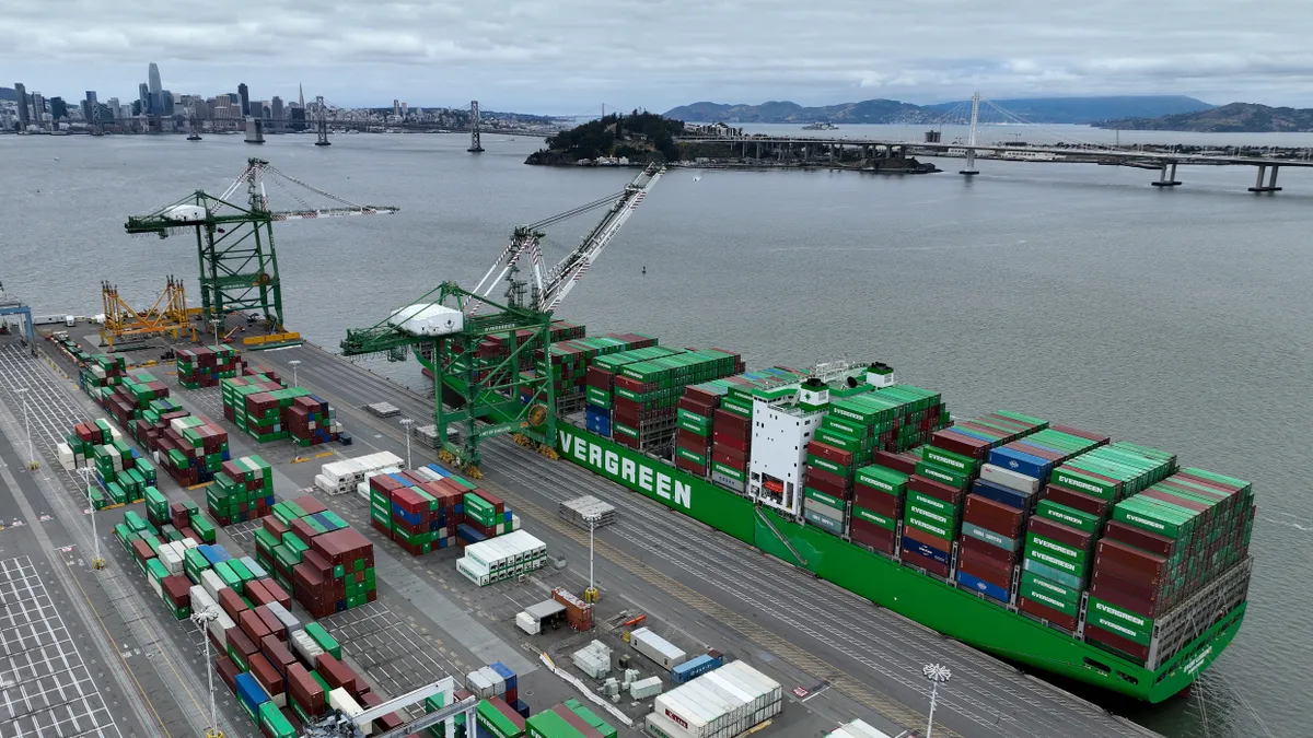 A container ship sits docked at the Port of Oakland.