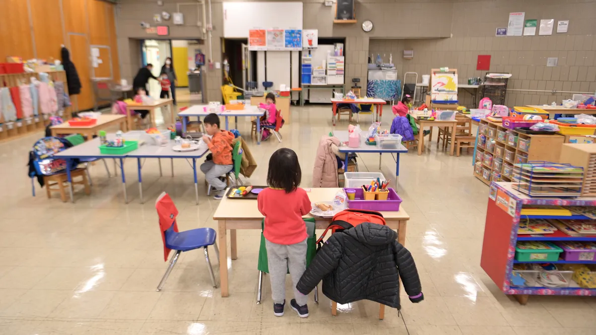 Preschool students from New York City Public Schools stand in a socially distanced classroom