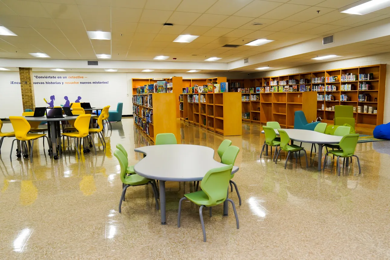 A school library as seen after a renovation with colorful chairs and bookshelves