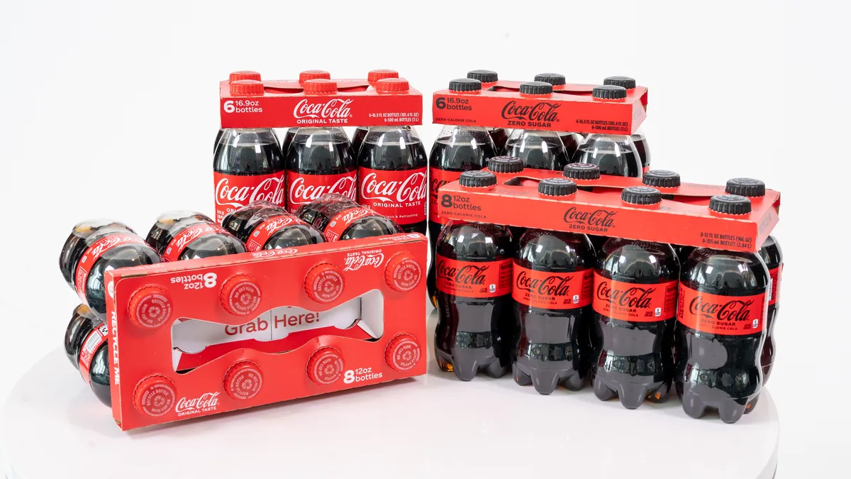 Four Coca-Cola bottle multipacks in paper can carriers