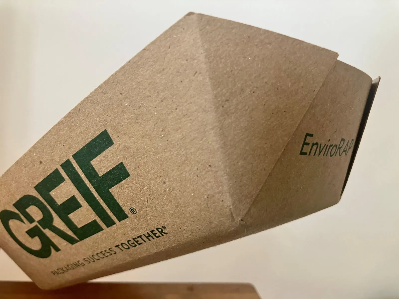 A paperboard food service boat bearing the Greif logo on the side and the &quot;Envirorap&quot; product name on the end