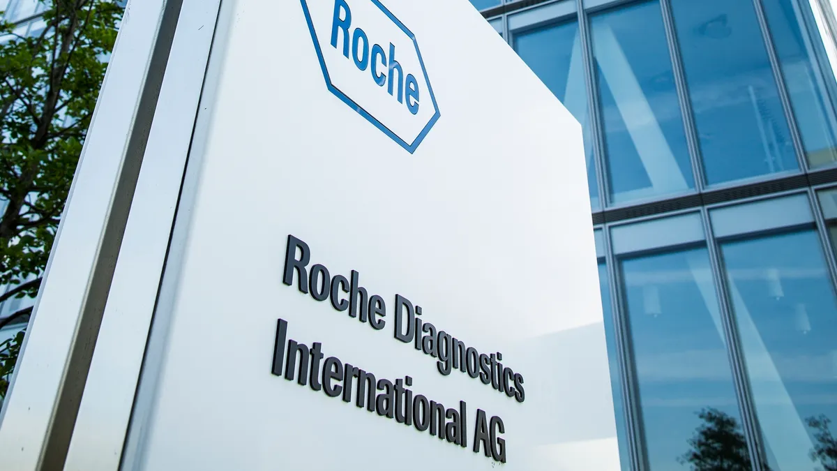 A Roche logo is seen on the side of a building.