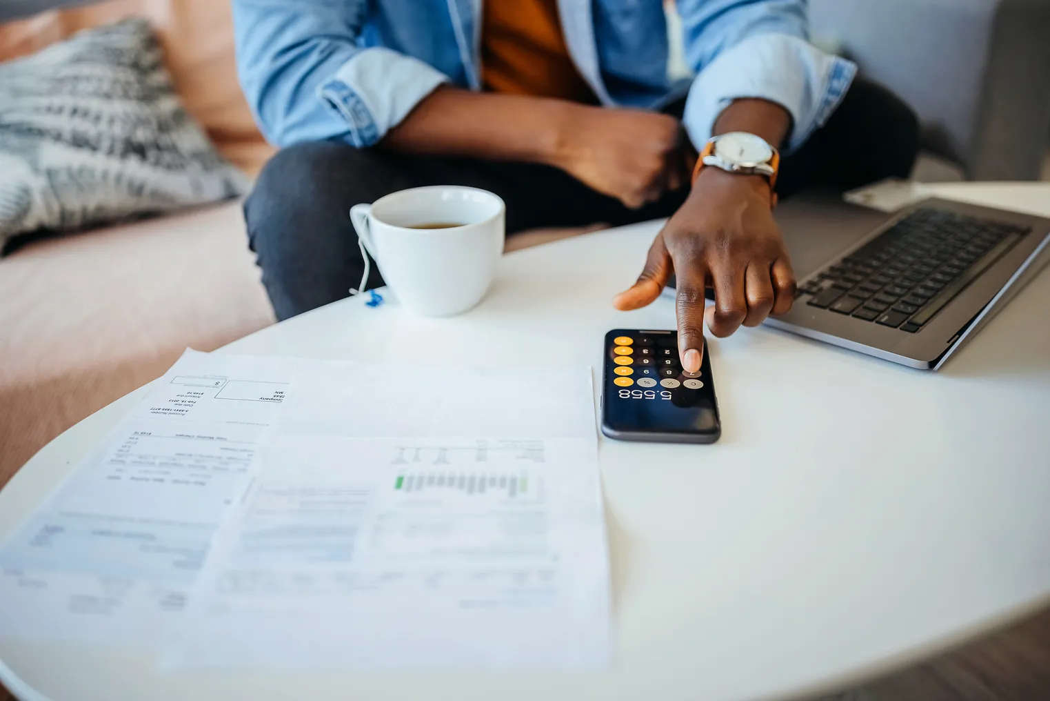 Unrecognisable man going over his finances.