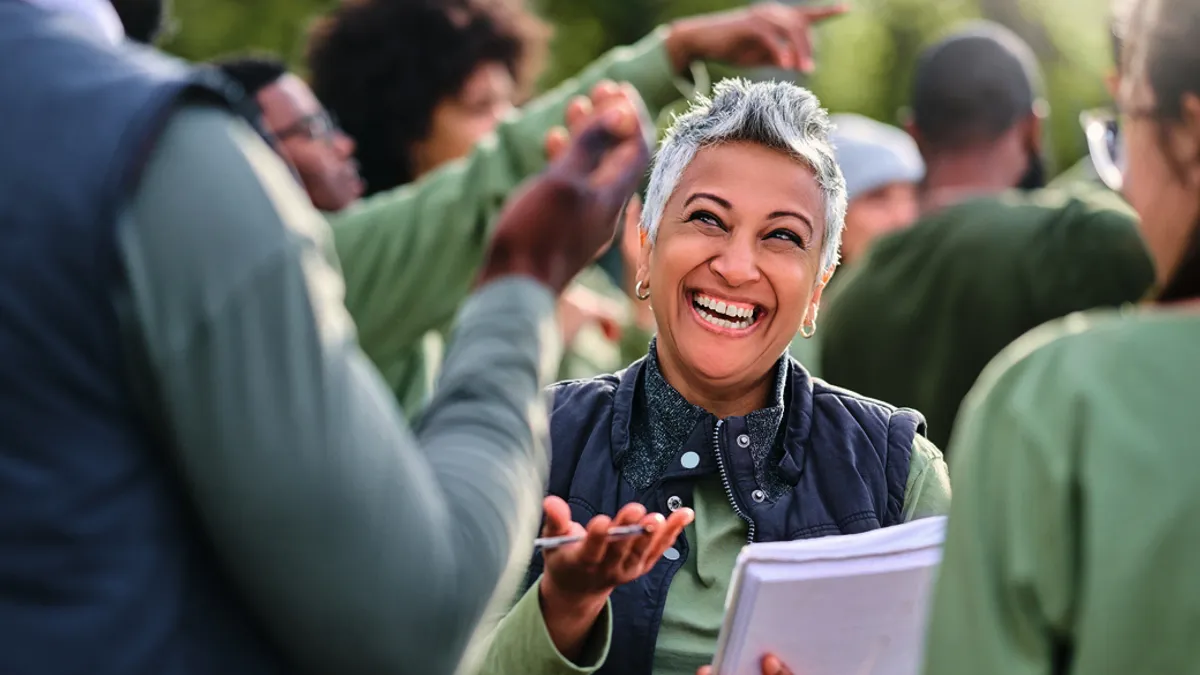 Team, happy woman or business people in meeting laughing at funny joke in discussion or collaboration together