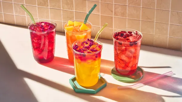 Four colorful drinks on a table.