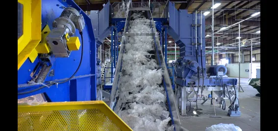 Conveyor belt with plastic film, within warehouse