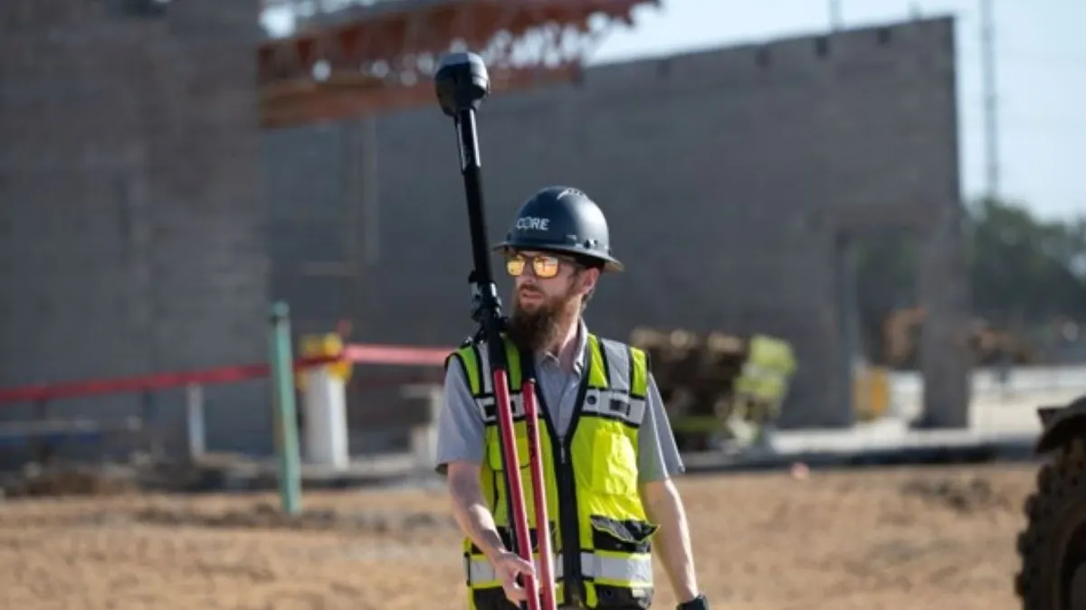 Construction man holding a piece of equipment