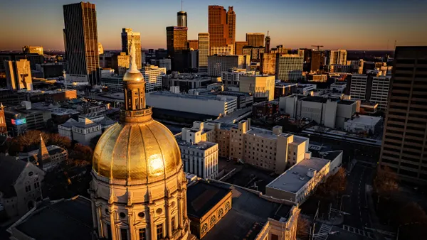 Aerial view of cityscape with golden dome in the foreground.